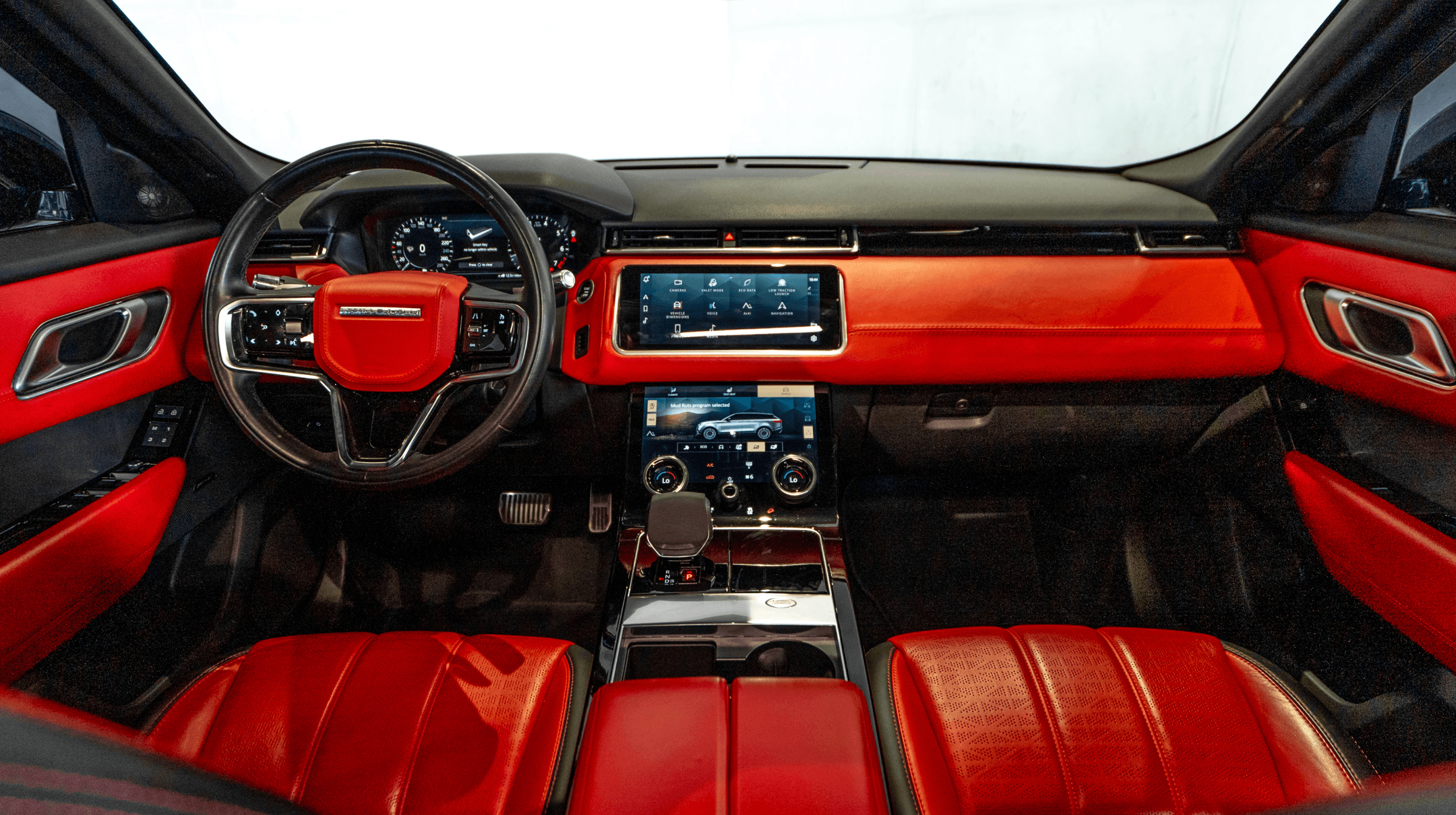 Red leather Range Rover Velar cabin with stacked centre-console displays