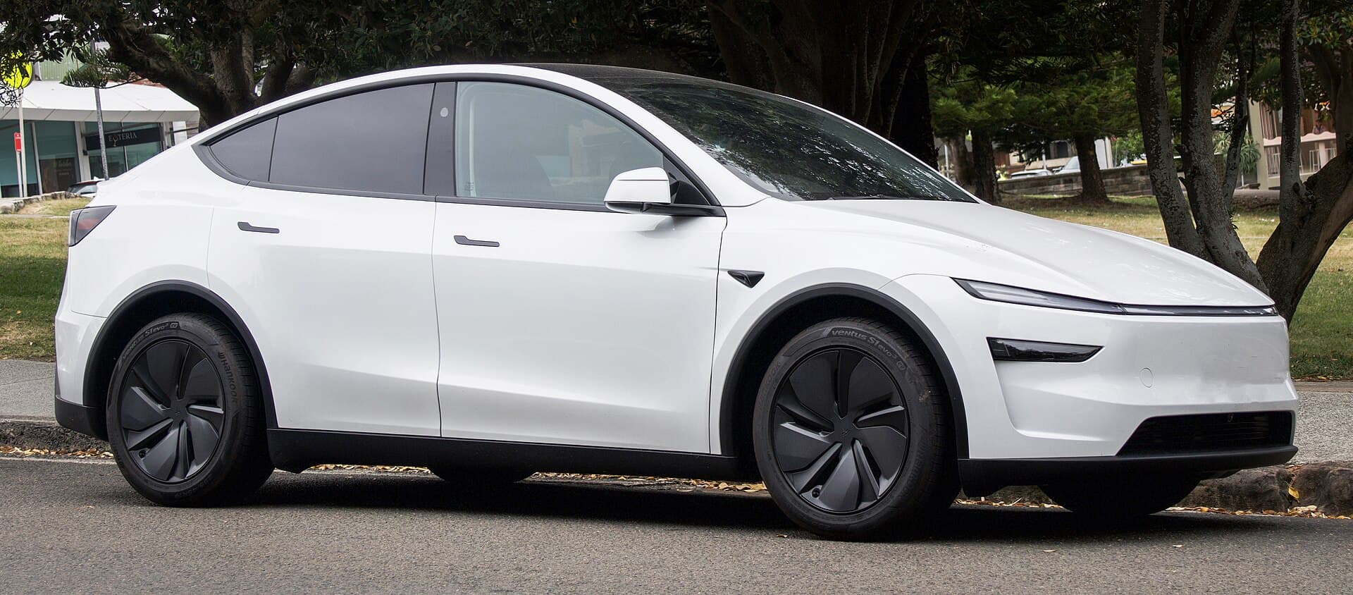 White refreshed Model Y with a front light bar