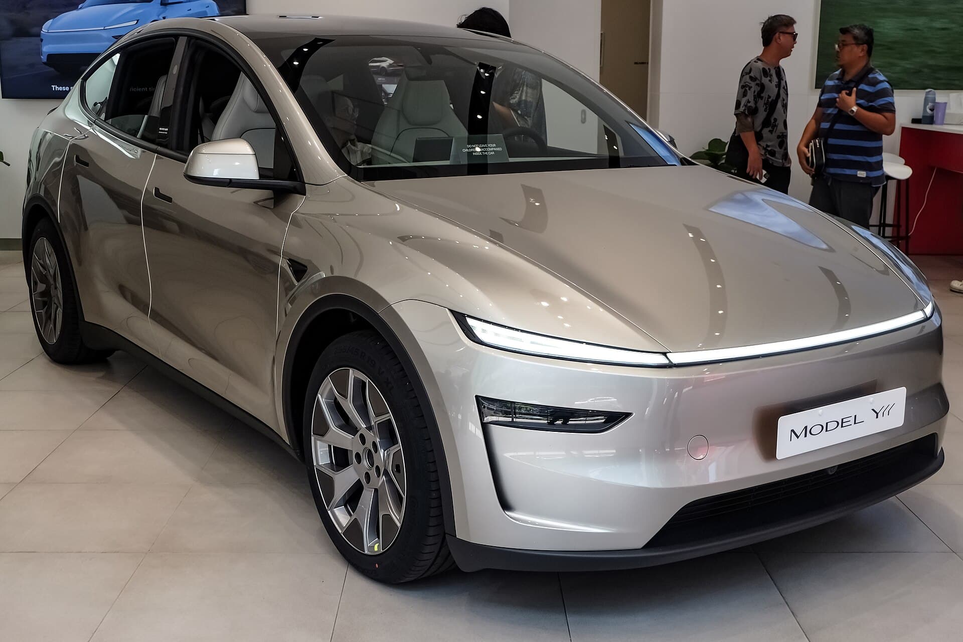 Silver Model Y L displayed in a showroom